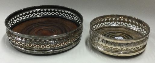 Two modern silver wine coasters with inset bases.