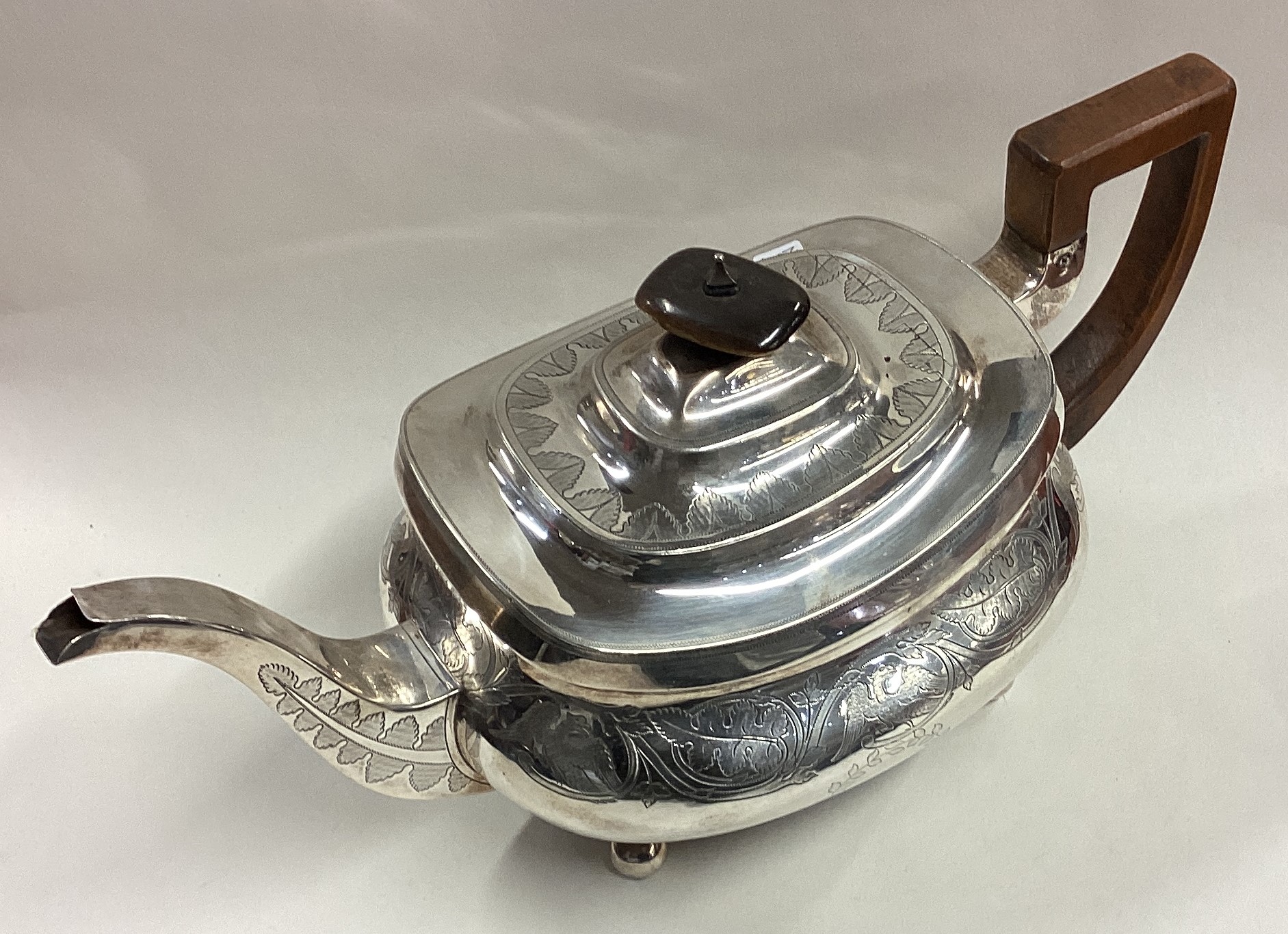 A George III silver teapot engraved with eagles and leaf decoration. - Image 2 of 5