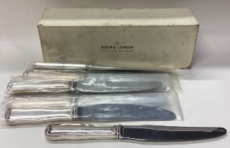 GEORG JENSEN: A rare boxed set of eight silver knives.