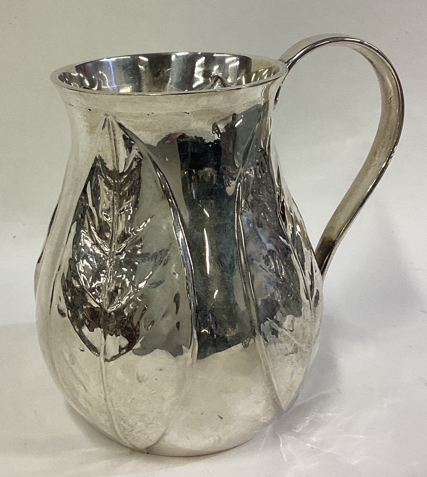 A rare contemporary silver mug chased with leaf decoration. - Image 2 of 3