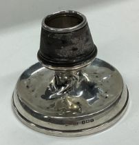 A rare silver match striker in the form of a candlestick.