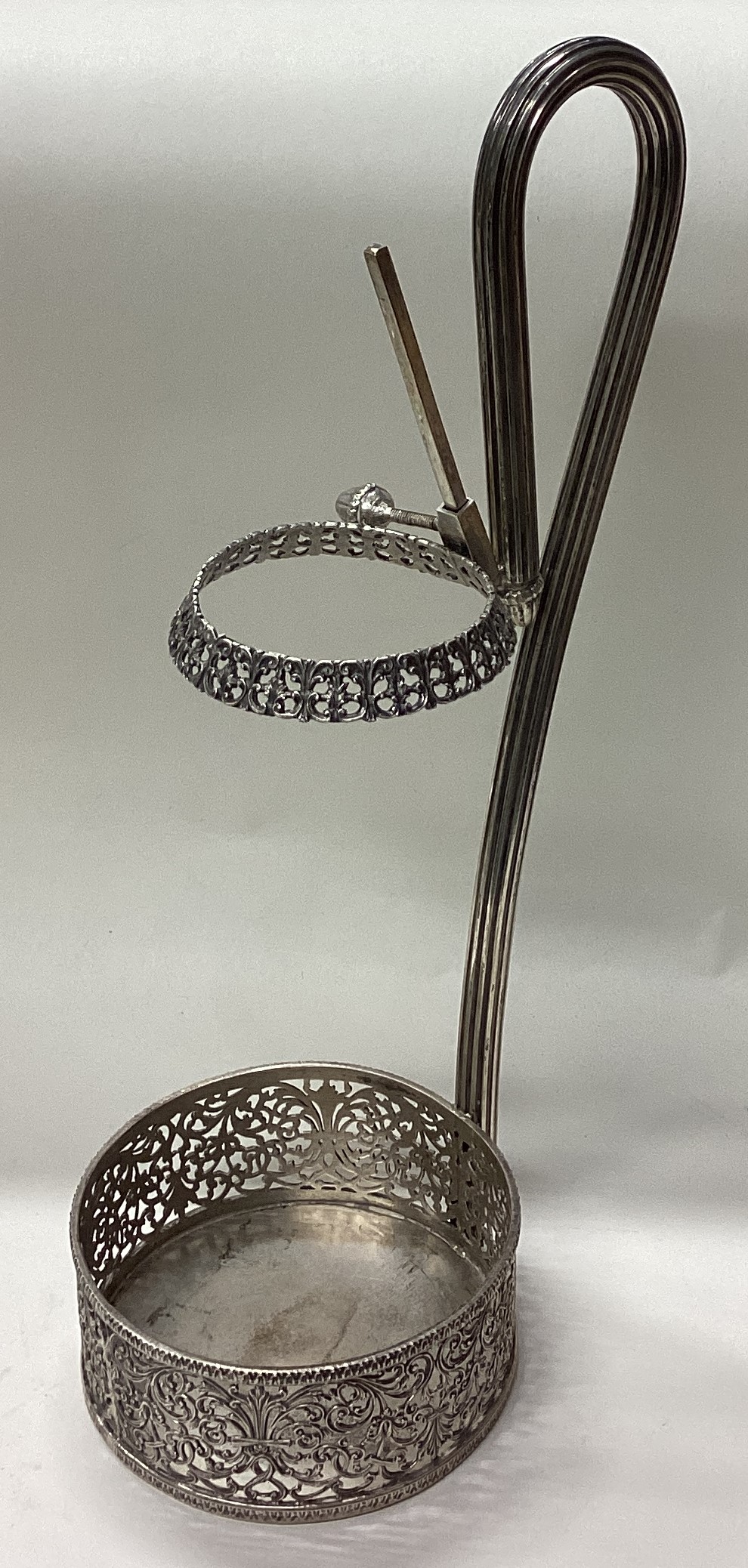 A large Continental silver wine bottle holder with pierced decoration.