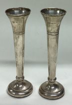 A pair of silver vases.