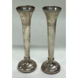 A pair of silver vases.