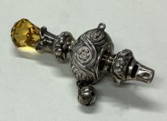 A silver rattle with stone handle. Circa 1900.