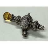 A silver rattle with stone handle. Circa 1900.