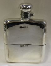 A large silver flask with detachable cup.