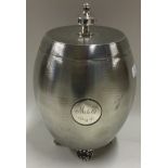 A heavy engine turned silver tea caddy with lift-off cover.