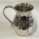 A rare contemporary silver mug chased with leaf decoration.