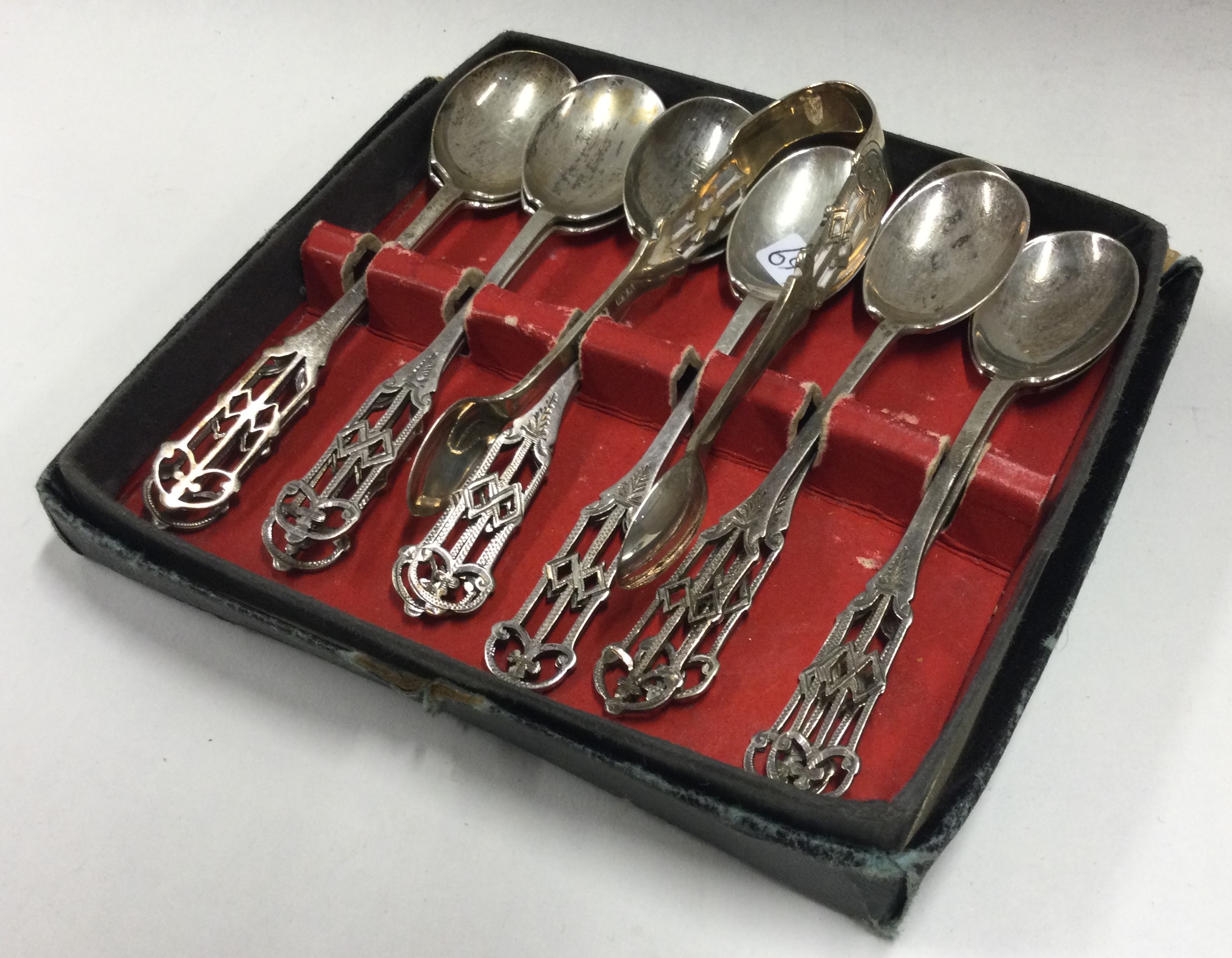 A boxed set of ten Edwardian silver coffee spoons together with matching tongs.