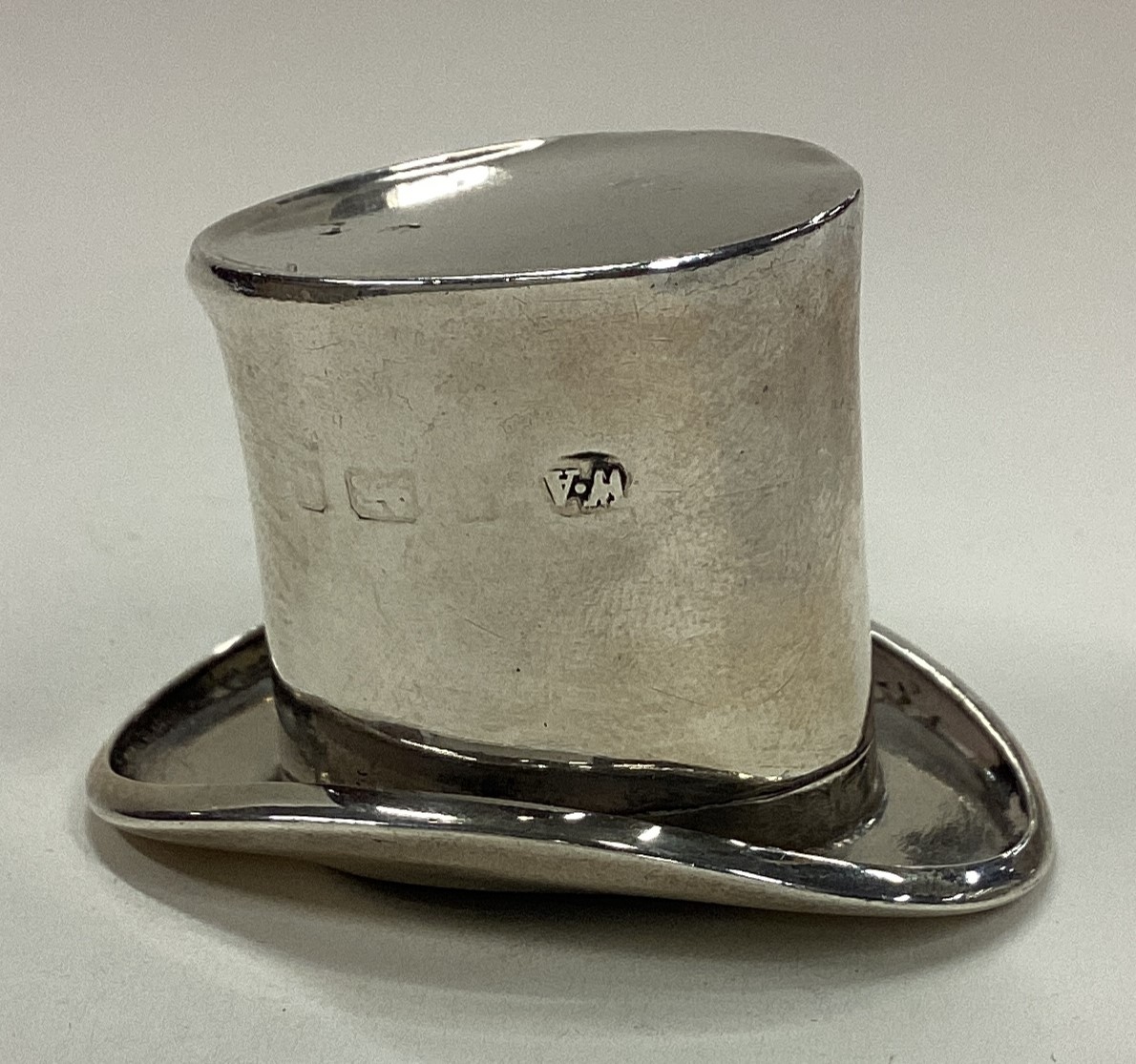 A silver model of a top hat. Birmingham.