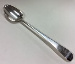 A large George III silver serving spoon with central armorial.
