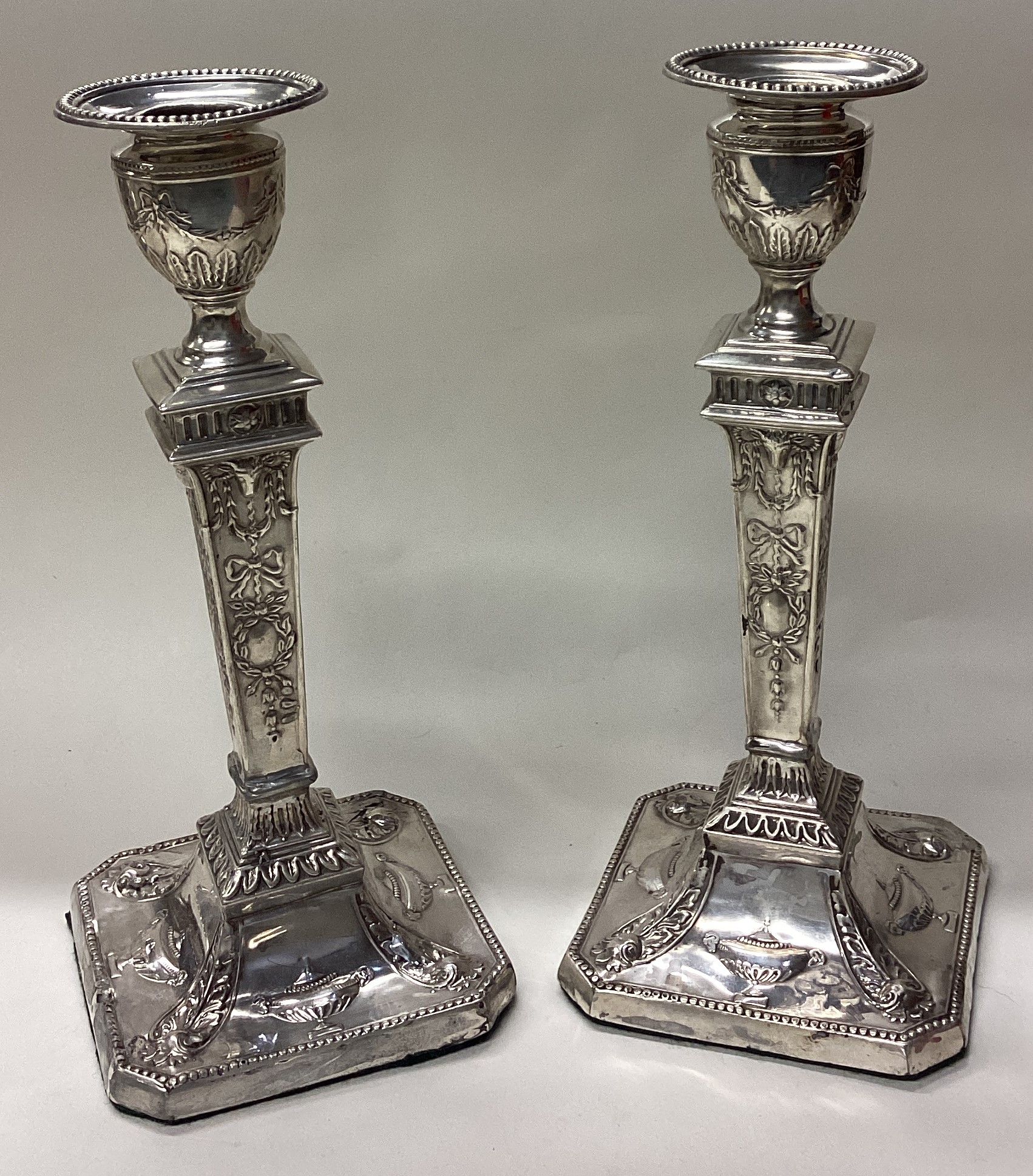 A fine pair of Neo Classical Victorian silver candlesticks.