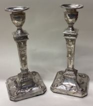A fine pair of Neo Classical Victorian silver candlesticks.