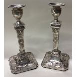 A fine pair of Neo Classical Victorian silver candlesticks.