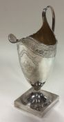 A George III silver jug with bright-cut decoration.