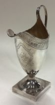 A George III silver jug with bright-cut decoration.