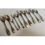 A large collection of silver fiddle pattern and other mustard spoons.