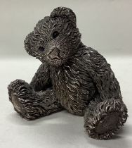 A novelty silver figure of a teddy bear.