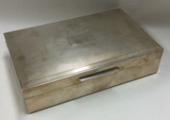 A heavy engine turned silver cigarette box with hinged lid.