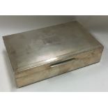 A heavy engine turned silver cigarette box with hinged lid.