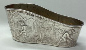 A Victorian silver shoe with chased decoration.