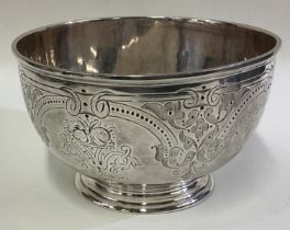 A Victorian silver bowl with engraved decoration.
