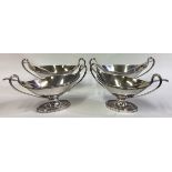 A find set of four George III silver twin-handled salts with spoons.