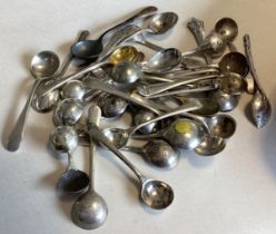 A large collection of miniature silver OE pattern salt spoons.