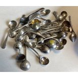 A large collection of miniature silver OE pattern salt spoons.