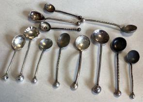 A group of silver bead edge miniature salt spoons.
