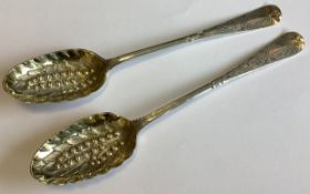 A matched pair of Georgian silver berry spoons.
