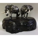 PATRICK MAVROS: A large pair of silver elephants on plinth.