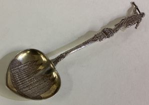 A heart shaped American silver spoon with figural handle.