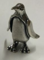 A silver figure of a penguin.