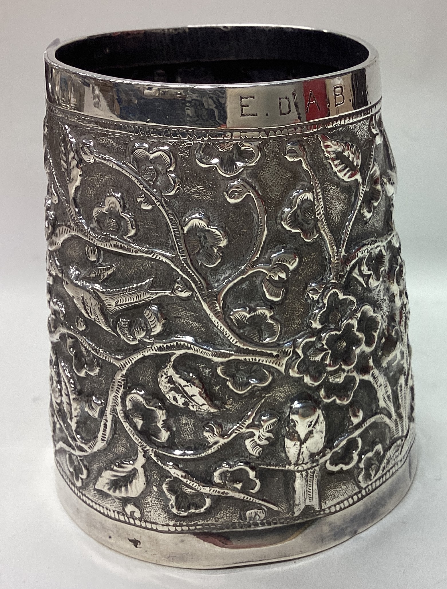 A 19th Century Indian silver mug embossed with birds. - Image 2 of 2