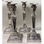 A rare and fine set of four Victorian silver candlesticks.