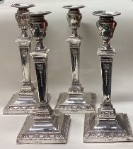 A rare and fine set of four Victorian silver candlesticks.