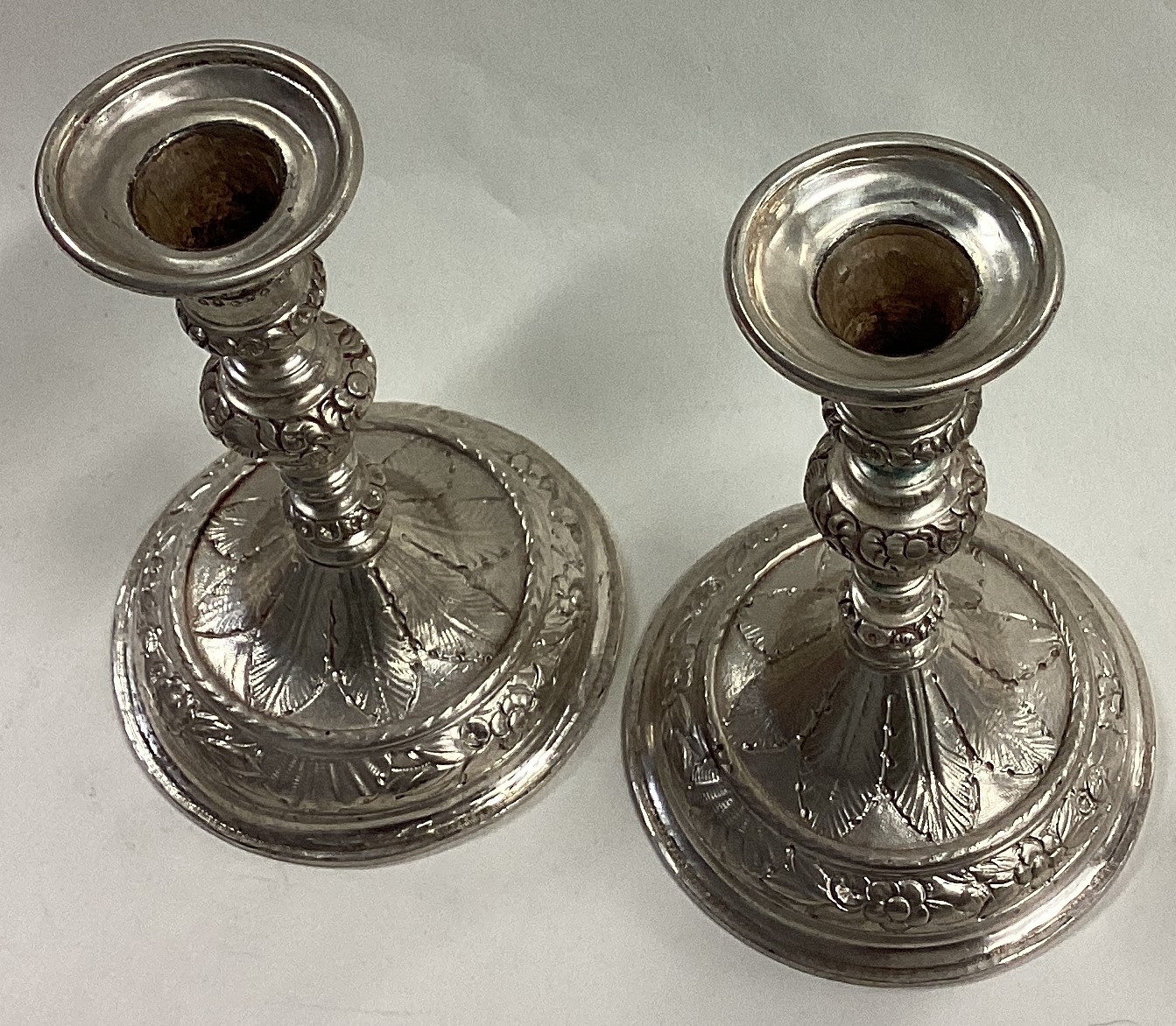 A pair of early Queen Anne cast silver candlesticks. - Image 2 of 4