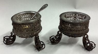 A pair of pierced silver salts with glass liners.