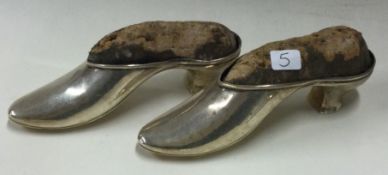 A good pair of silver pin cushions in the form of shoes.