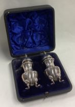 A heavy pair of cast silver peppers.