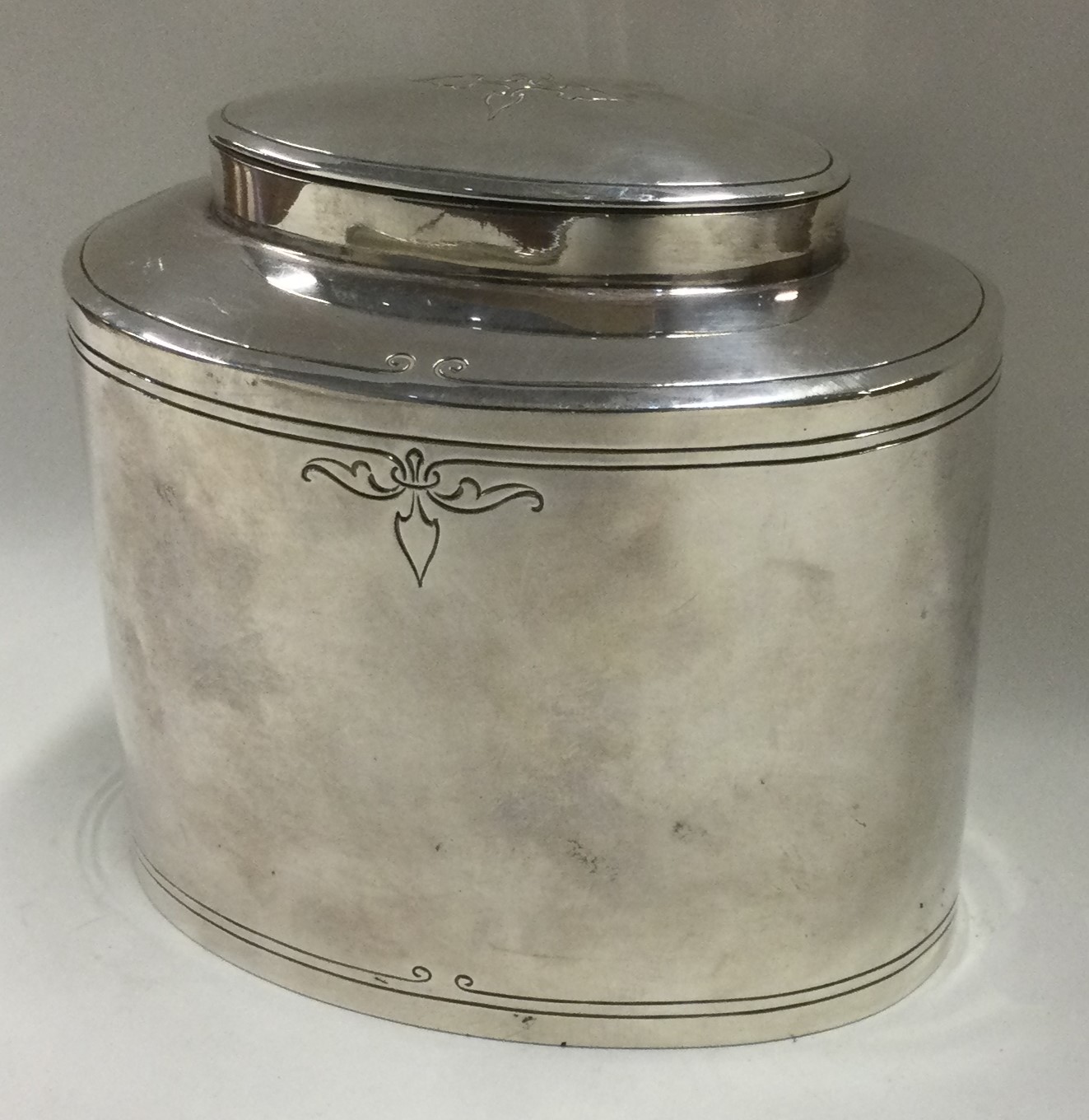 A heavy Sterling silver tea caddy with floral decoration.