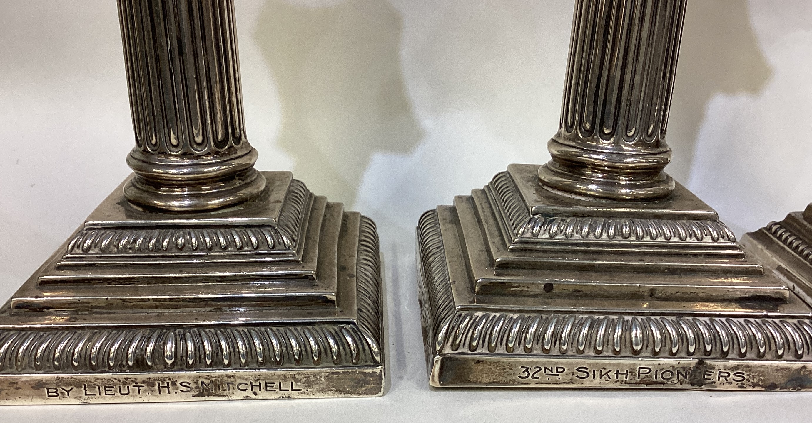A heavy pair of silver Corinthian column candlesticks of typical form together with one other. - Image 2 of 4