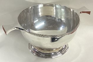 A large plain silver bowl with Celtic decoration.