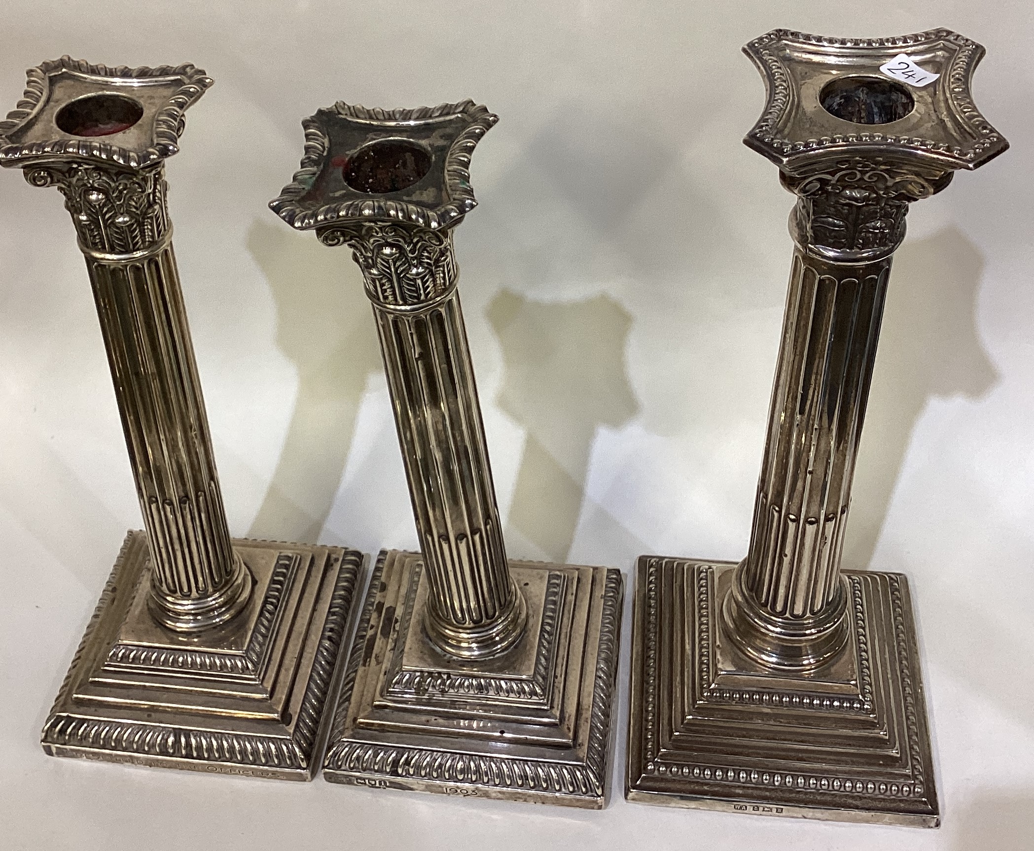 A heavy pair of silver Corinthian column candlesticks of typical form together with one other. - Image 4 of 4