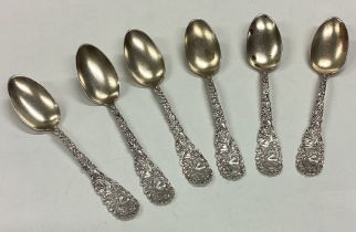 A set of six American silver spoons embossed with flowers and butterflies.