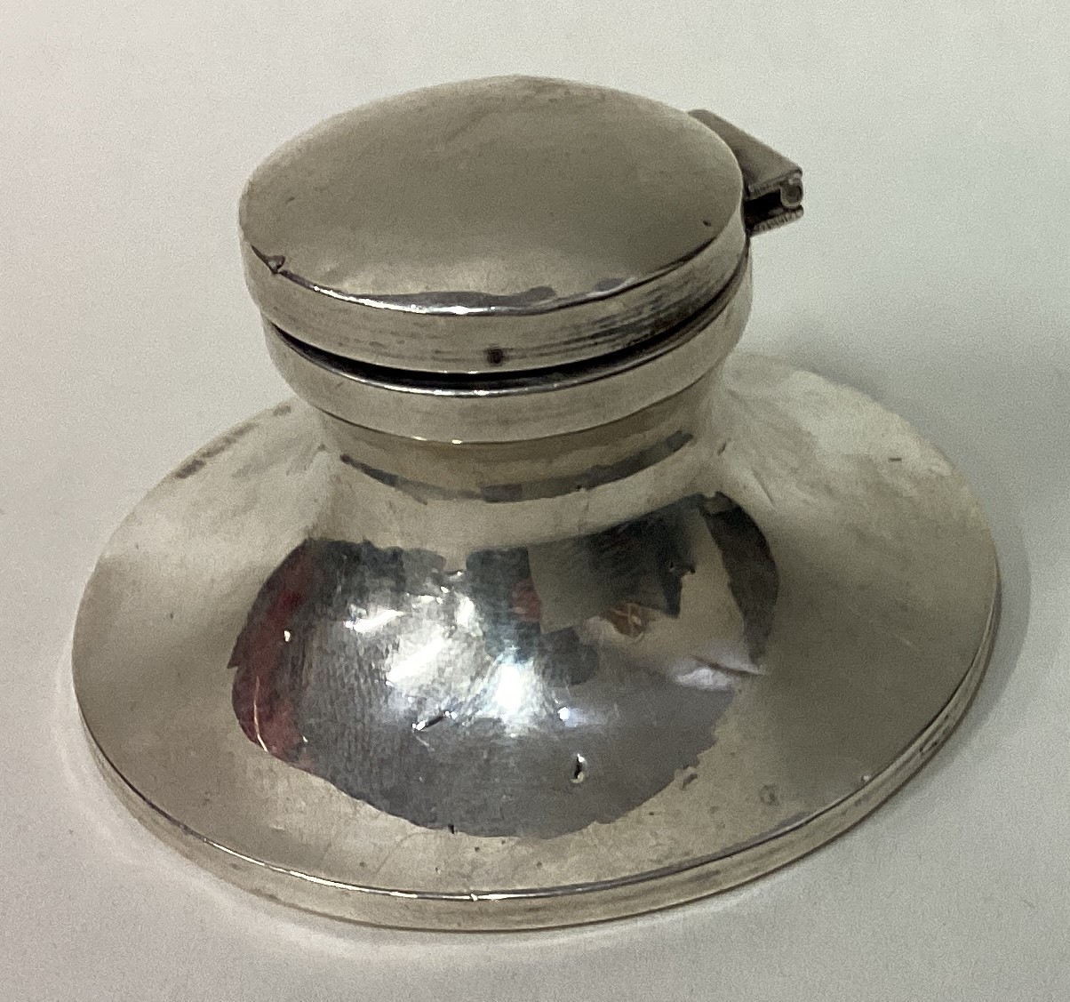 A silver inkwell.