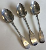 A group of three heavy silver fiddle pattern dessert spoons.