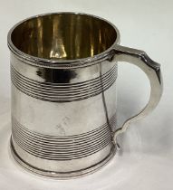 A Georgian silver reeded mug. London 1824.